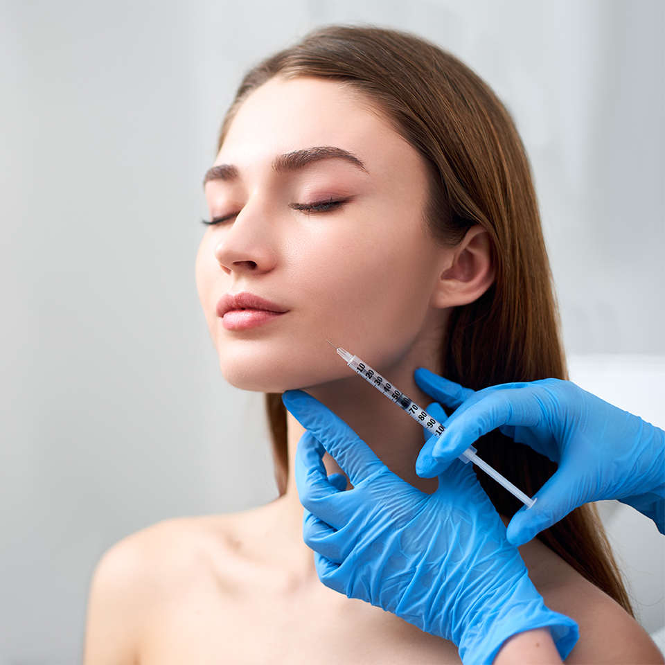 Woman receiving facial injection treatment for wrinkle reduction, showcasing aesthetic enhancement in a clinical setting.