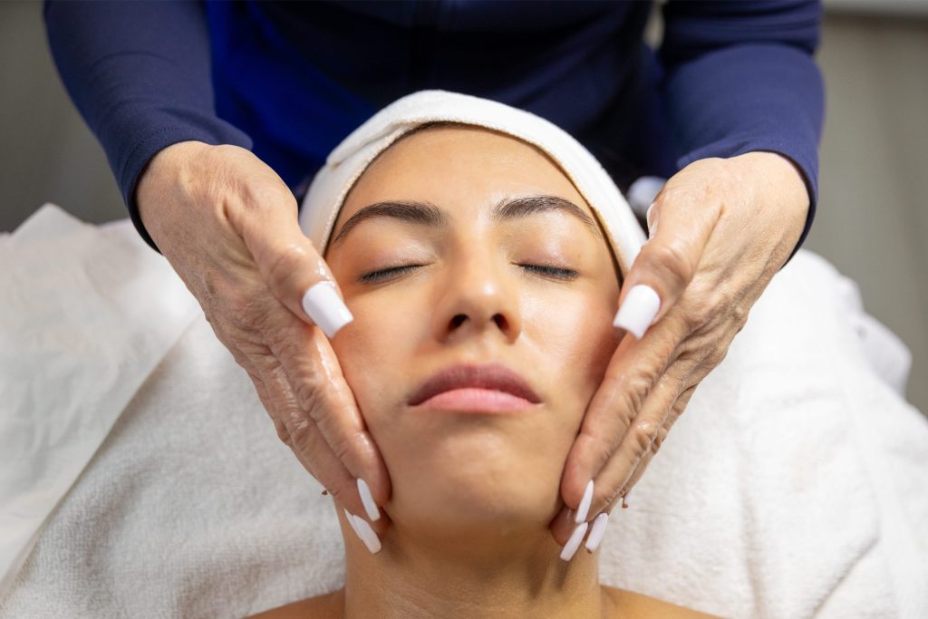 Woman receiving a facial treatment at a medical spa, highlighting aesthetic services for facial rejuvenation and beauty enhancement.