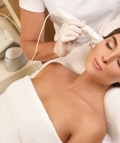 Woman during face skin diagnostic in the professional beauty salon