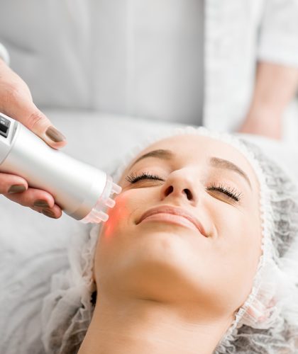 Young woman during a facial massage with professional tool at the medical center